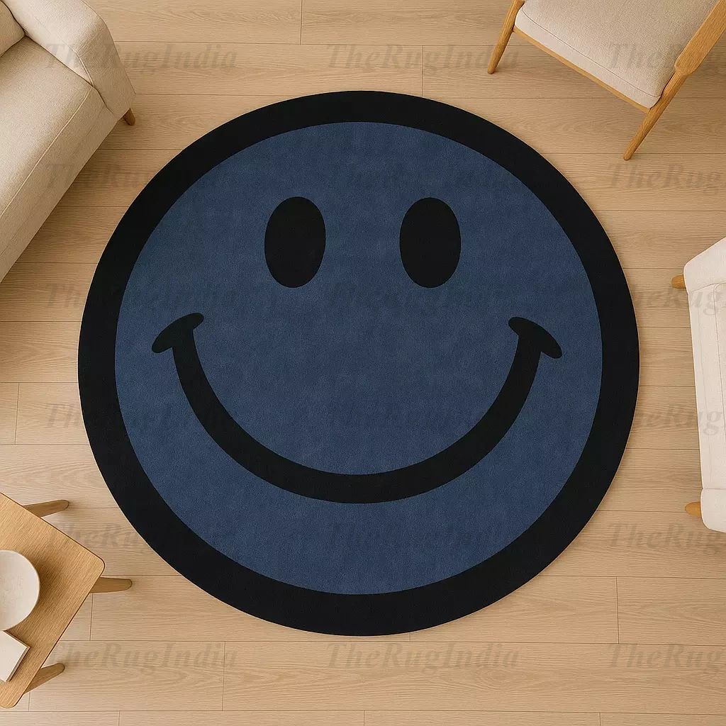 Hand-tufted round blue rug with black smiley face, placed in a modern living room with light wood flooring and minimalist chairs.