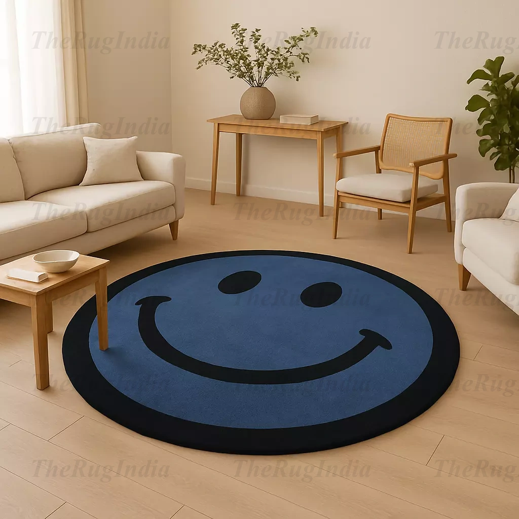 Hand-tufted round blue rug with black smiley face, placed in a modern living room with light wood flooring and minimalist chairs.